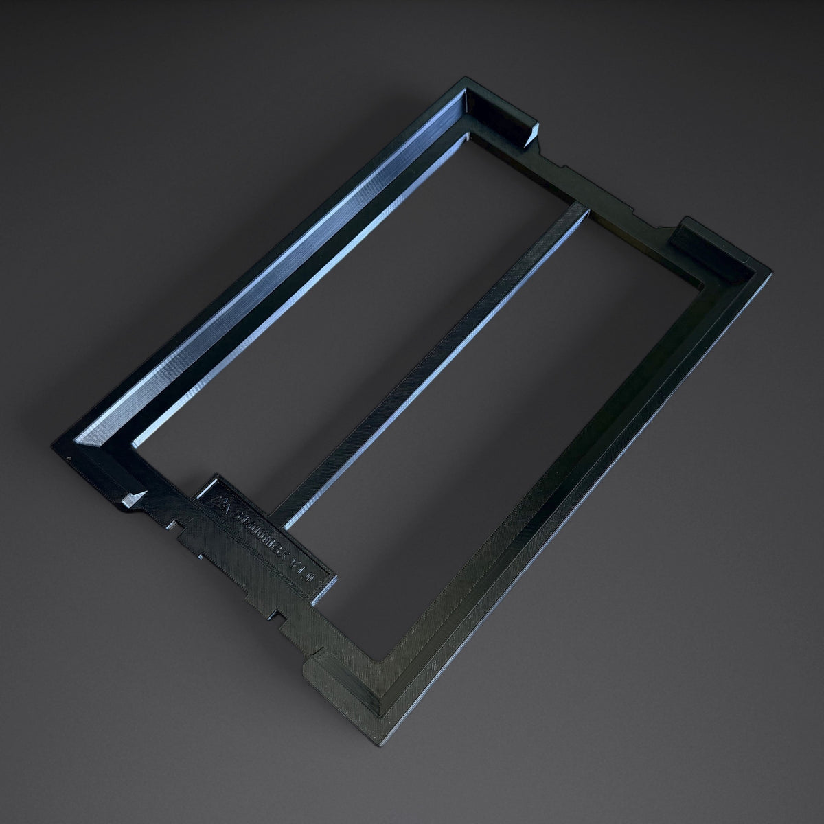 Black one-piece Mountaineer Maker adapter for the Klein MODbox 54500MBX organizer box, shown on its own